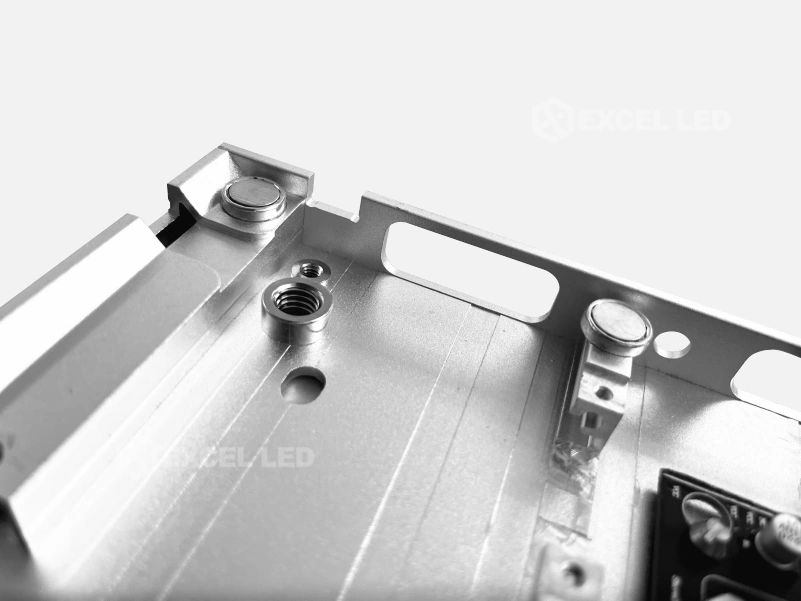 aluminum extrusion LED display frame corner showing locating pins, magnet seats and threaded inserts